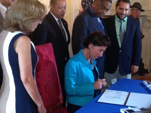 Gov. Gina Raimondo signing the Community-Police Relationship Act