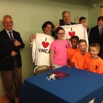 Gov. Raimondo and Sen. Whitehouse with YMCA campers after signing the healthcare reform executive order
