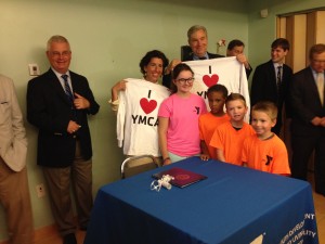 Gov. Raimondo and Sen. Whitehouse with YMCA campers after signing the healthcare reform executive order