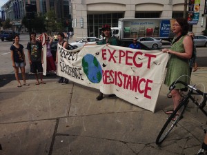 Protestors rally in front of Providence Chamber of Commerce as Gov. Raimondo announces Clear River Energy Center