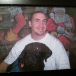 Steve and Rescue, in front of the ACI visiting room mural he painted.