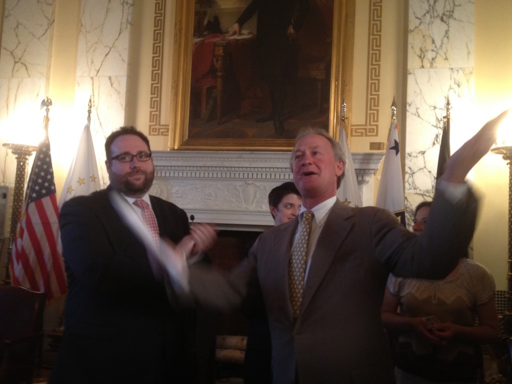 Ray Sullivan, of Marriage Equality Rhode Island, and Gov. Chafee celebrate his executive order recognizing same sex marriages from other states. (Photo by Bob Plain)