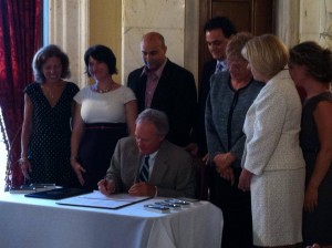 Gov. Chafee signs into law the Temporary Caregivers Insurance bill. 