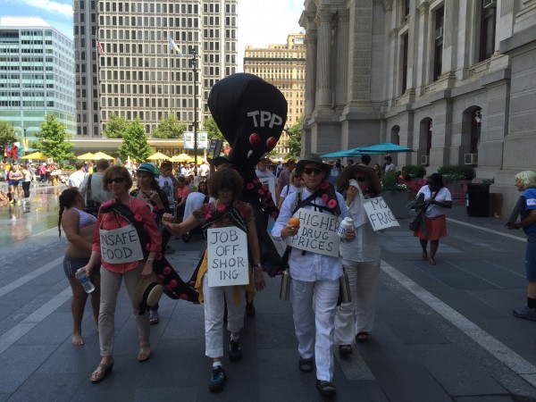 Marchers carry an anti-TPP "octopus."