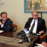 Secretary of State Nellie Gorbea and congressmen David Cicilline and Jim Langevin listen to voting rights activist Jane Koster.