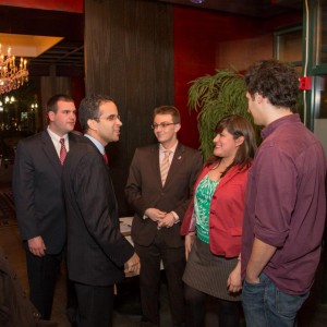 Providence Mayor Angel Taveras confers with Kristina Fox, who is flanked by Young Dems Alex Morash and Aaron Regunberg.