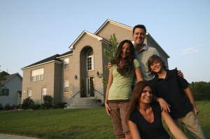 Well-off white family in front of their house