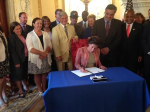 Gov. Raimondo signing the Executive Order to form the Justice Reinvestment Working Group